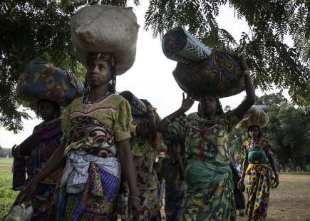 Displaced women carrying their belongings arrive in Bossangoa, Central African Republic, after fleeing violence