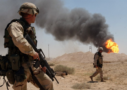 US troops watch burning oil fields in wake of US invasion in 2003