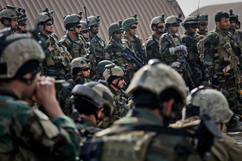 Afghan soldiers discuss an upcoming tactical training exercise in Kabul province Feb. 11, 2013. The training is part of the transition of security to the Afghan National Security Force before coalition forces depart in 2014.