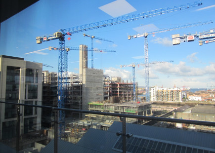 Crane Skyline. Tech development is slowly encroaching on the shipping and maritime activity that remains at the far end of the docklands. Photo taken from the top of the Accenture building in the Silicon Docks.