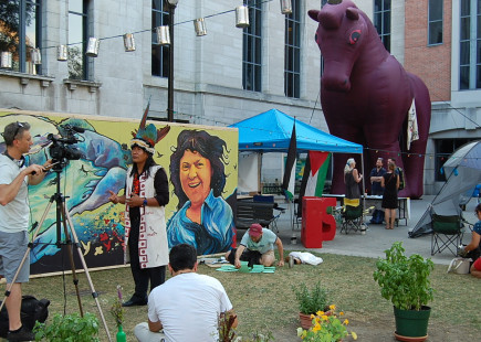 First nation spokesperson gives interview at Place Pasteur, Montreal.